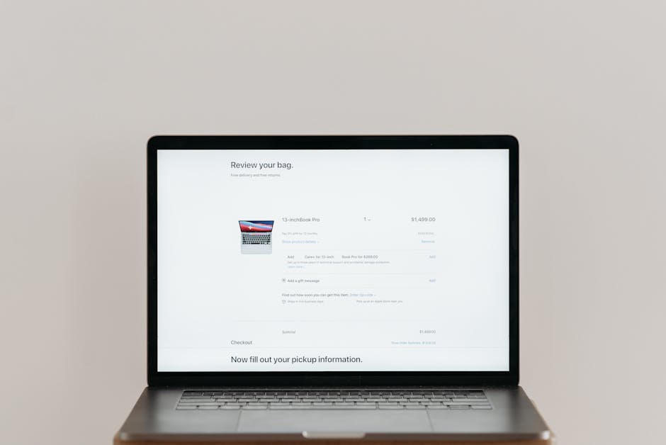 Minimalist laptop showing an online checkout screen on a white background, ideal for tech context.
