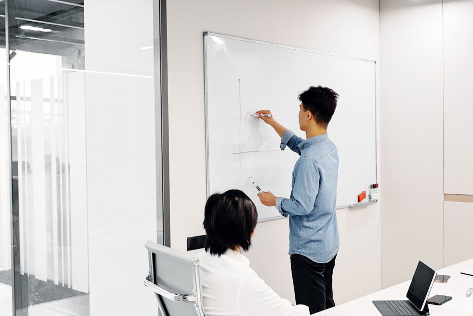 Business professional drawing graph during office presentation with colleague