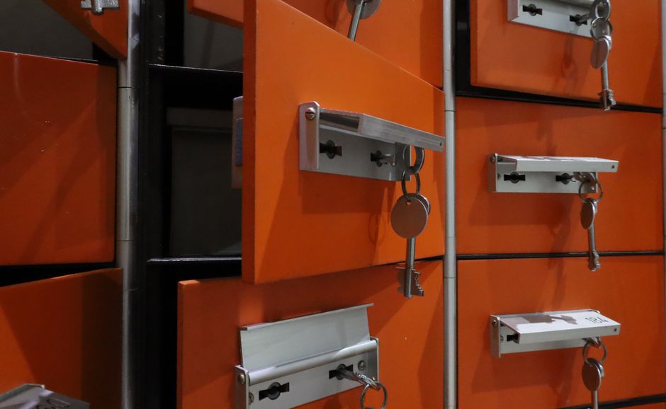 Orange lockers with metal keys highlighted in an indoor setting.